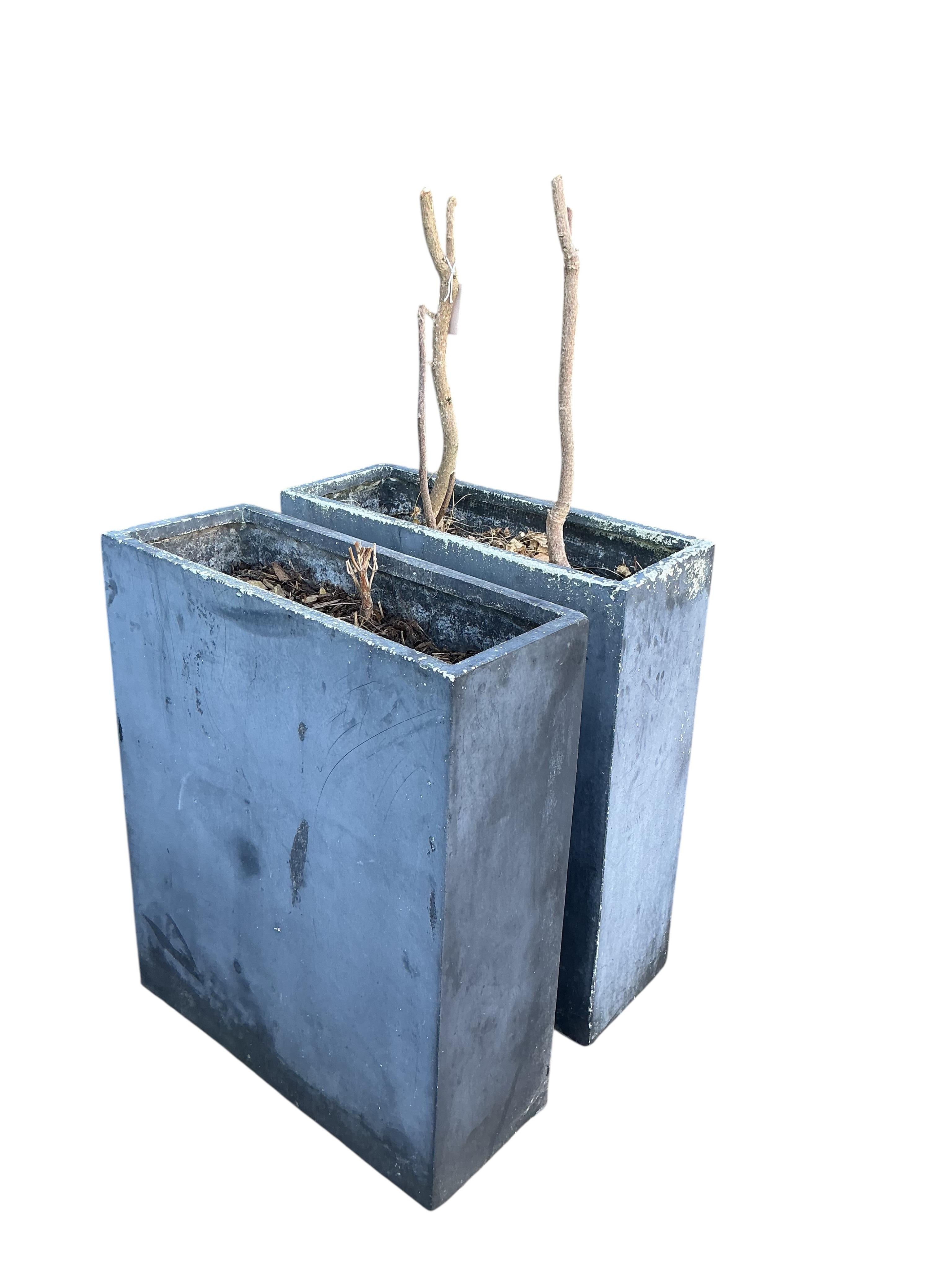 A pair of fibreglass faux lead garden planters, width 60cm, depth 23cm, height 74cm